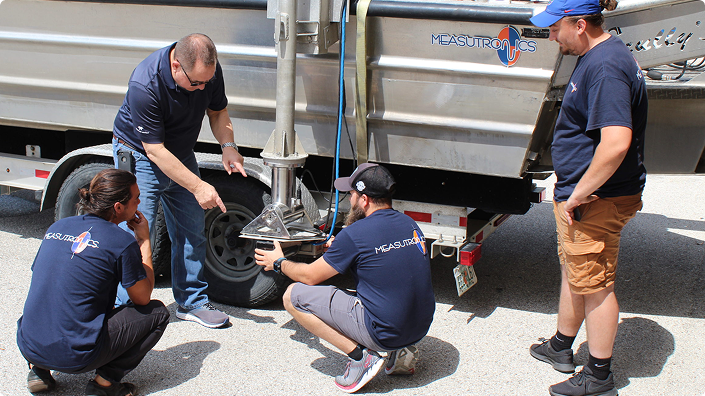 Measutronics Employees Working On Machinery